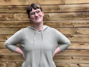 Porträt von Rebecca Biging vor Holzwand